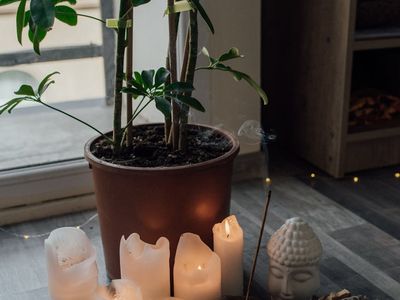 A peaceful meditation corner with candles and stones.